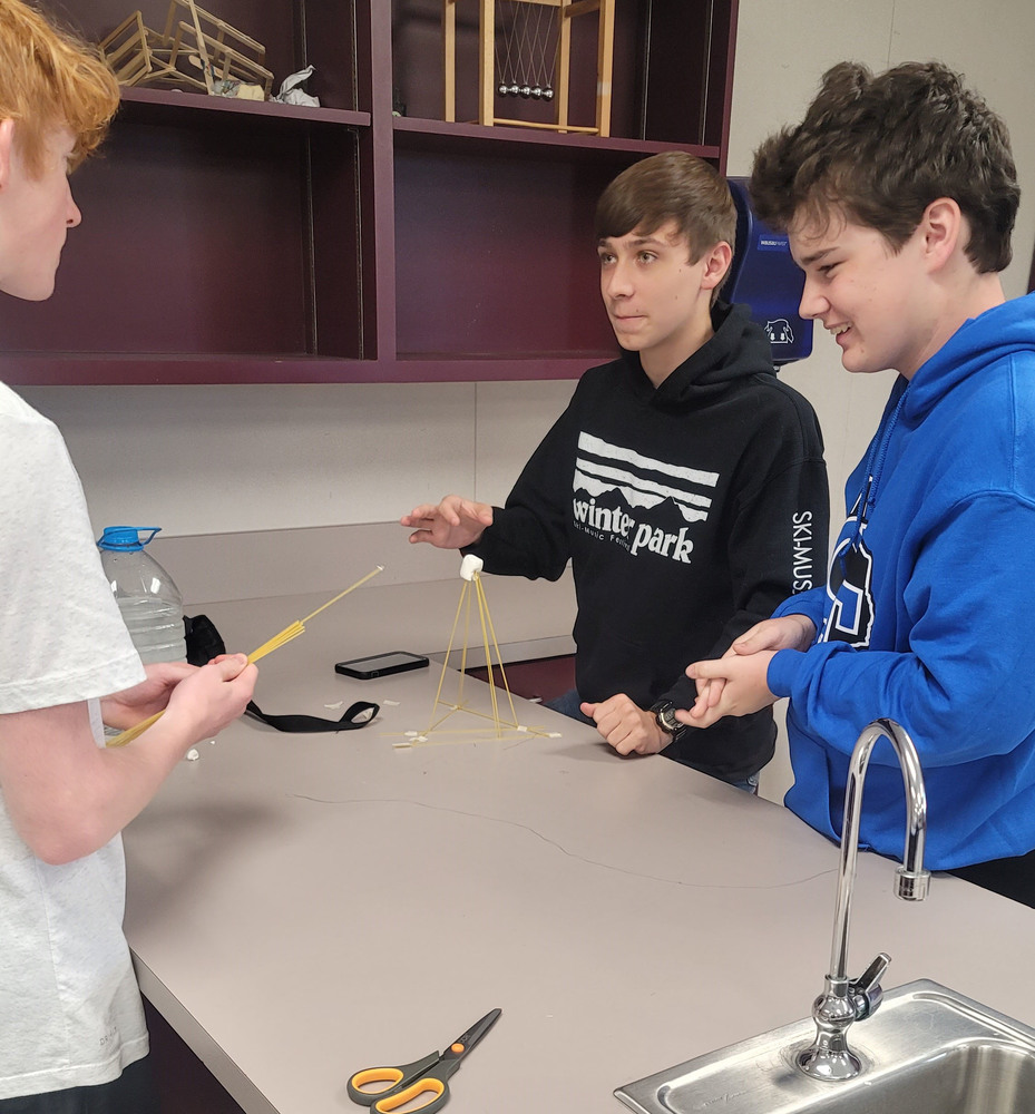 students building tower with supplies given