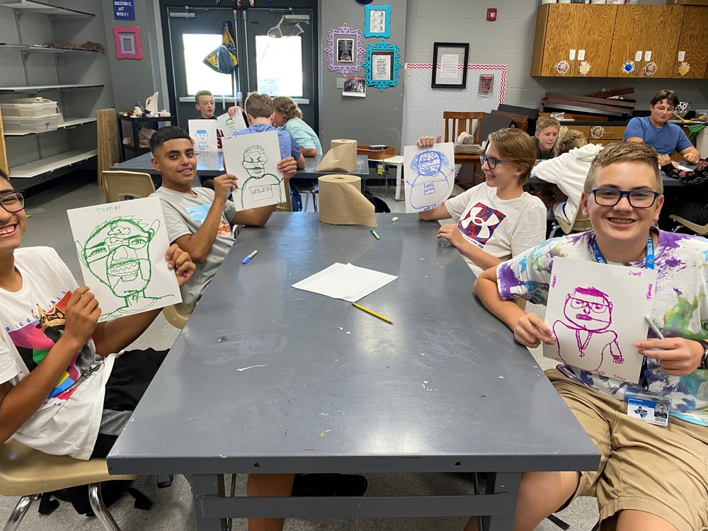 Students holding pictures