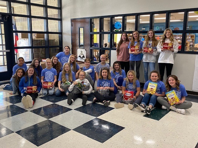 Students holding food items
