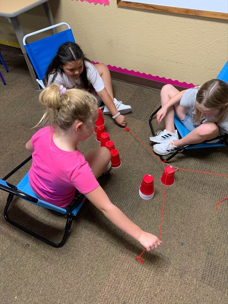 Students working with red solo cups